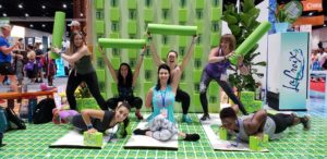 Sweat Pink squad with foam rollers and yoga mats at the La Croix booth