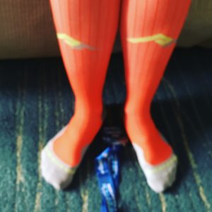 Post-race, rocking my Pro Compression socks in BibRave Orange with A Major Award!